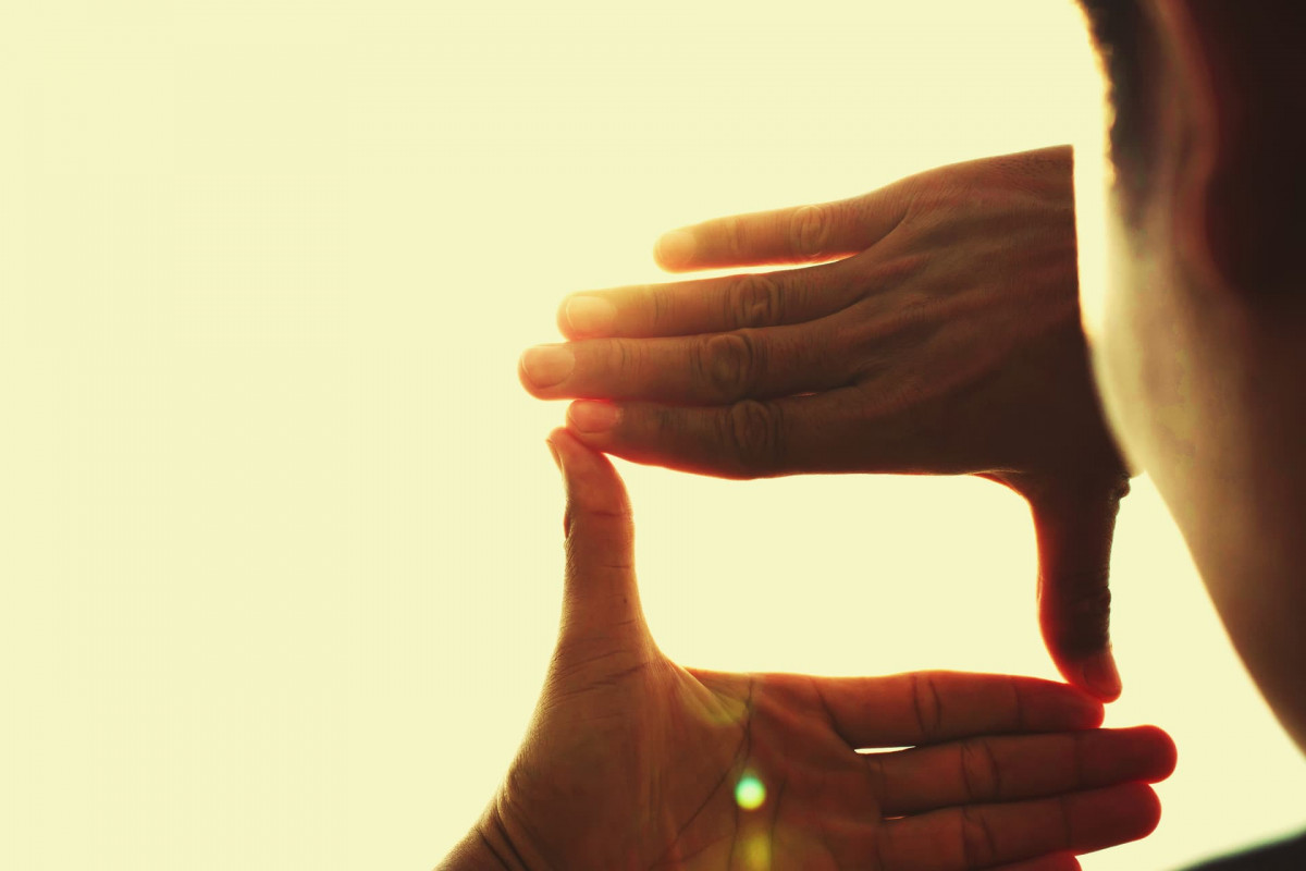 Person creating a frame with their hands